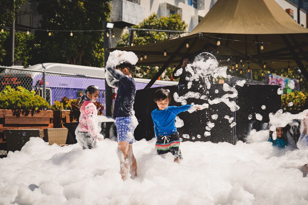Kids playing with foam at an Oogubi events in San Francisco