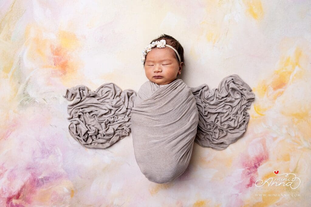 Newborn posed with soft neutral blankets