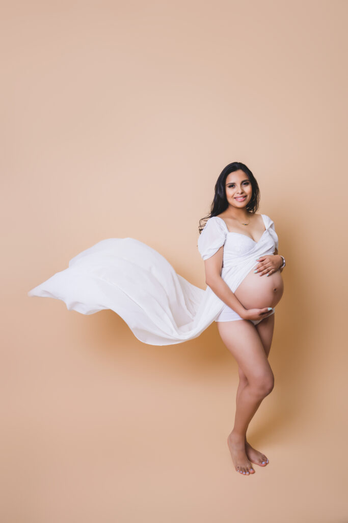Mother-to-be smiling during maternity photoshoot