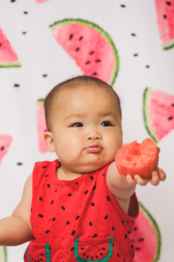 Toddler exploring birthday snacks during Marin shoot