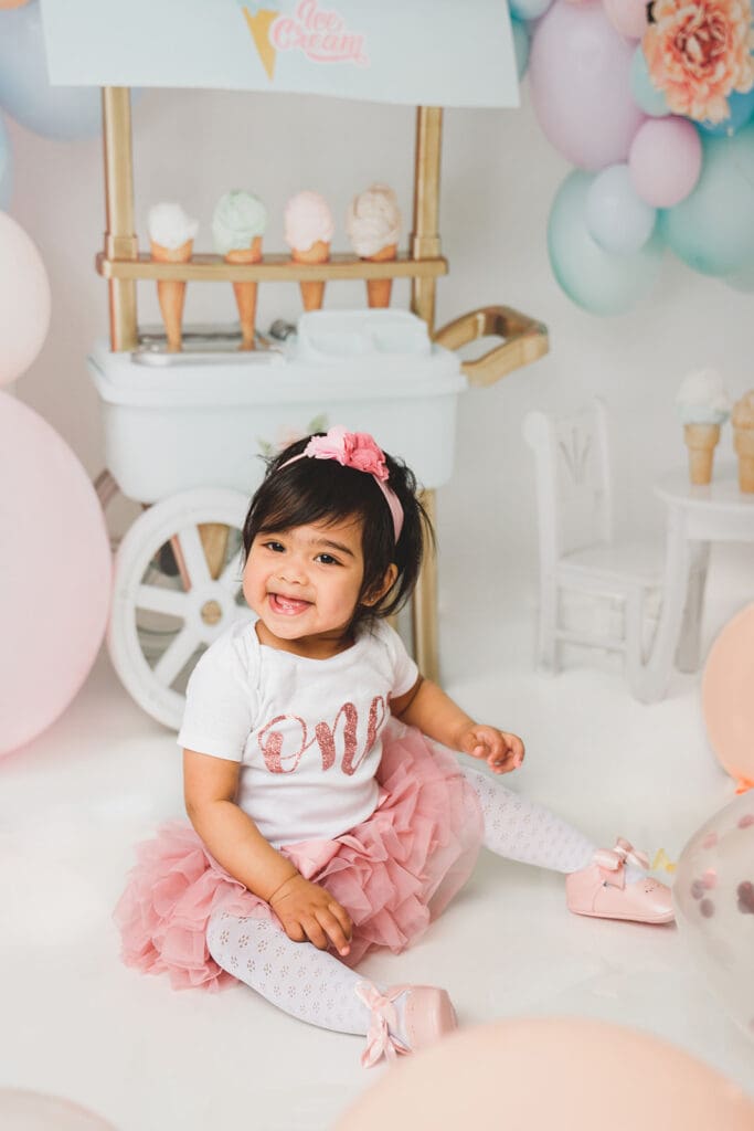 Toddler giggling with balloons at Sausalito studio
