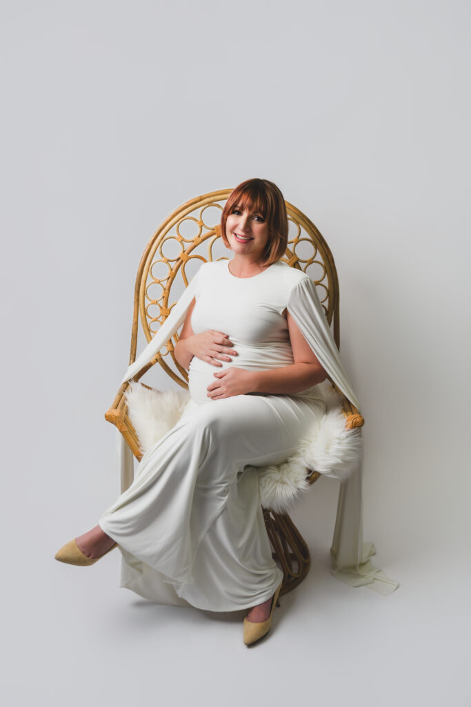 Mother-to-be smiling during maternity photoshoot