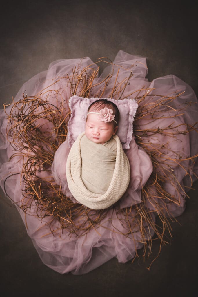 Sleeping baby in basket for newborn photoshoot