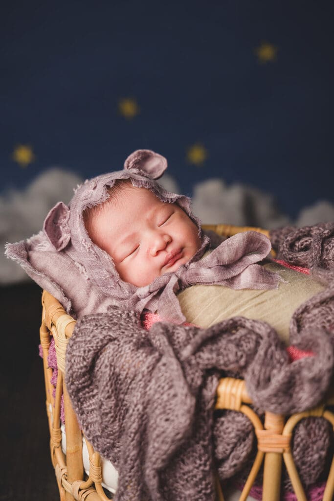 Sleeping baby in basket for newborn photoshoot