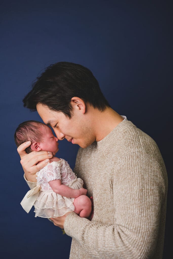 Parents holding newborn in studio session