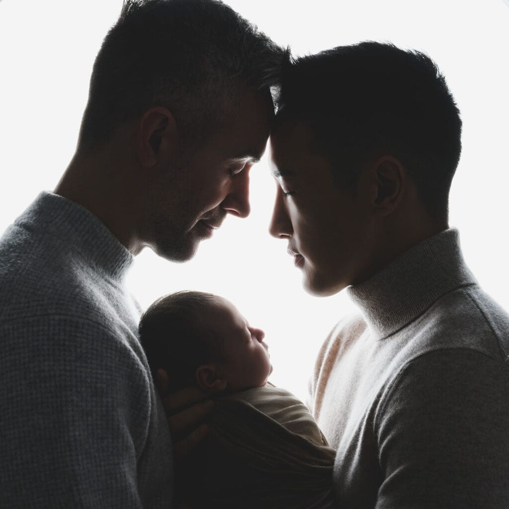 Parents holding newborn in studio session