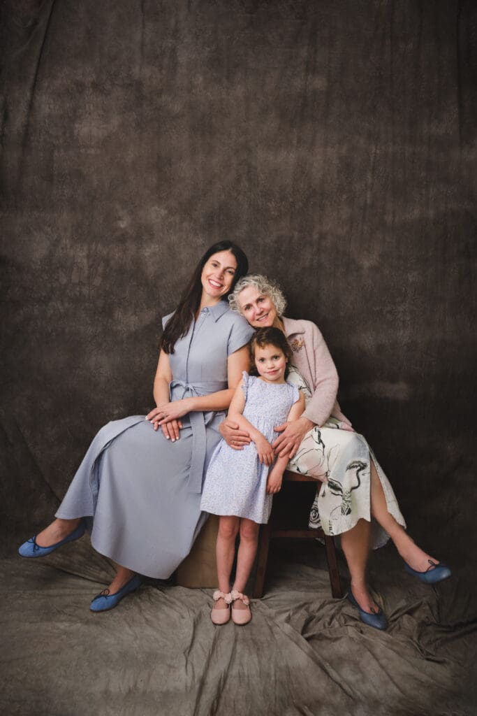 3 generations smiling together during family photo session