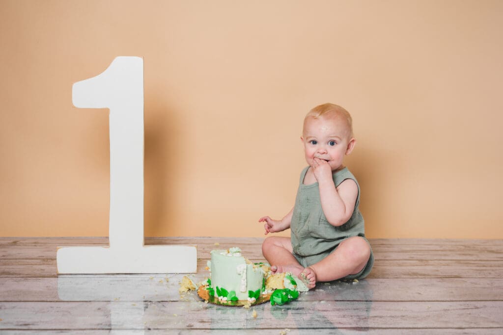 Baby enjoys cake on first birthday