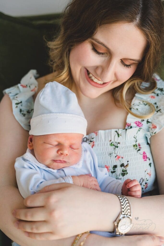 A proud and happy new mama holding baby boy.