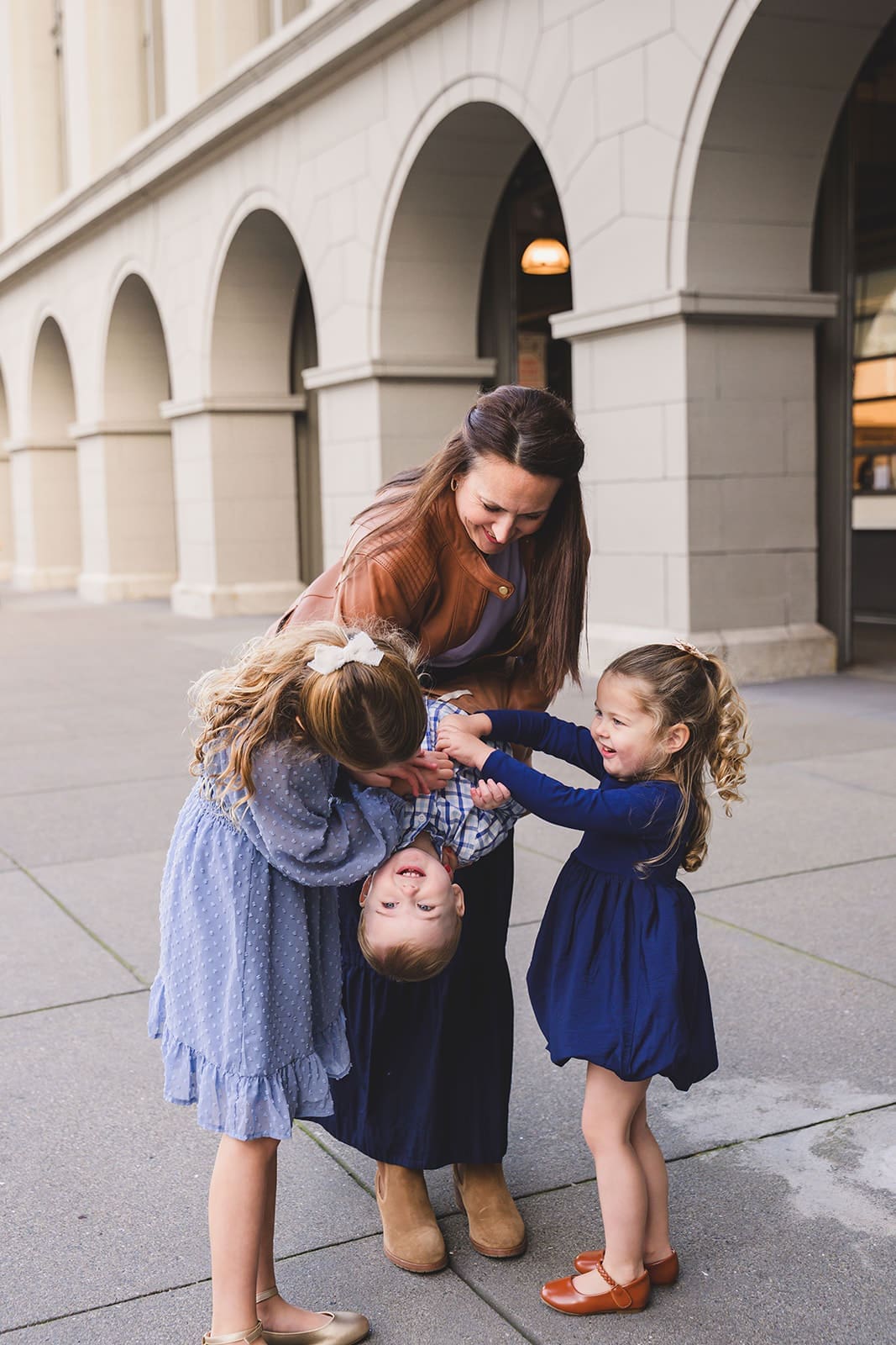  Family photos at the San Francisco Ferry Building with three young children playing along the Embarcadero | Mini Anna Photography