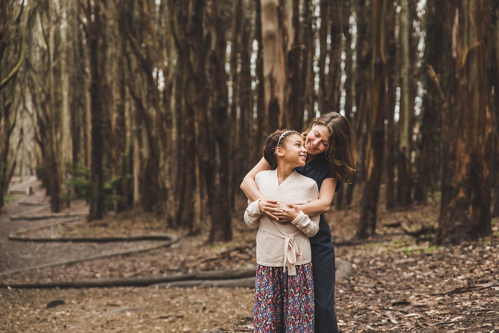 Family photos at Lovers Lane in the Presidio surrounded by eucalyptus trees and soft forest light