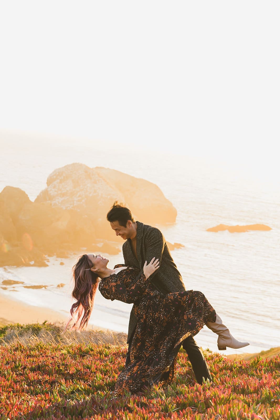 Candid family photos at Marin Headlands with coastal cliffs, golden sunset light, and wind-swept movement