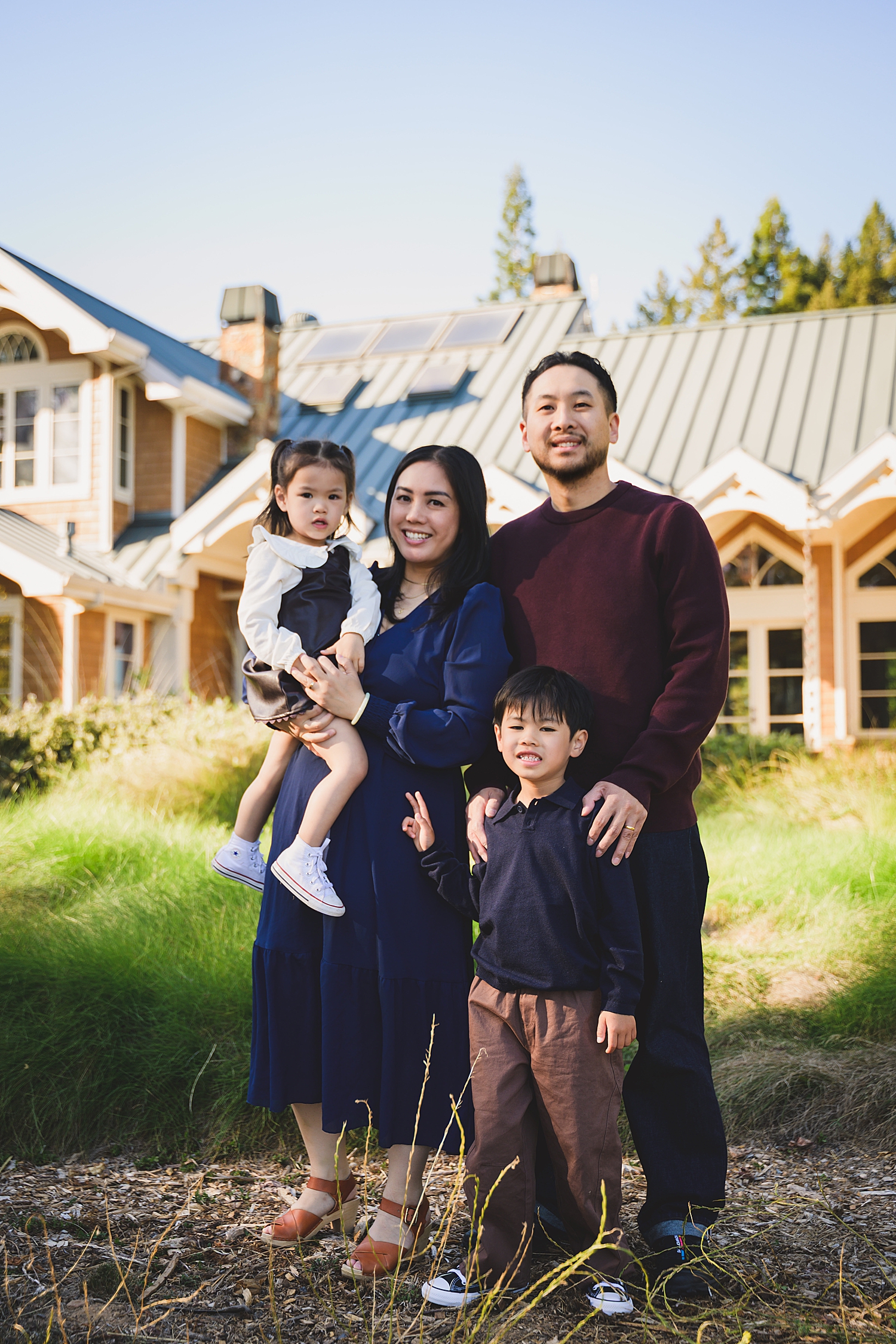 parents with two kids in front of building showing what to wear for family photos
